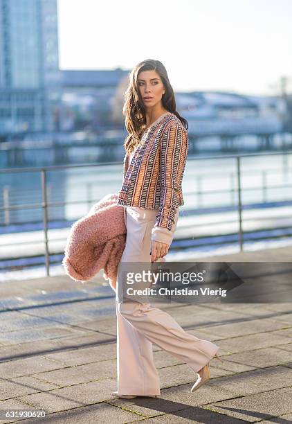 Vicky Heiler wearing a pink teddy coat Marc Cain, white creme Marc Cain wide leg pants, knit during the Mercedes-Benz Fashion Week Berlin A/W 2017 on...