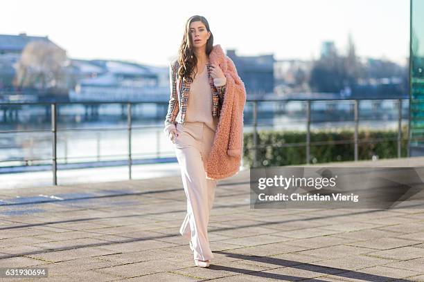 Vicky Heiler wearing a pink teddy coat Marc Cain, white creme Marc Cain wide leg pants, knit during the Mercedes-Benz Fashion Week Berlin A/W 2017 on...