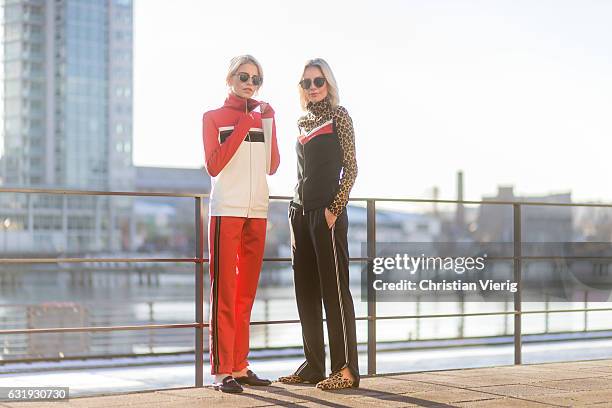 Caro Daur wearing a red track suit and Lisa Hahnbueck wearing a black track suit with leopard print and Marc Cain loafers during the Mercedes-Benz...