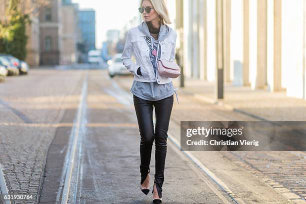 Lisa Hahnbueck wearing a white Marc Cain jacket, grey Marc Cain hoody, pink Marc Cain bag, leather pants, Marc Cain heels, sunglasses during the...