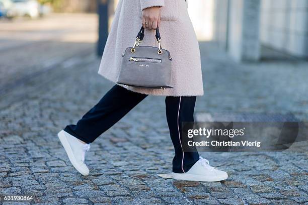 Nina Schwichtenberg wearing a nude Marc Cain wool coat, grey Marc Cain bag, navy Marc Cain jogger pants, white turtleneck, white sneaker during the...