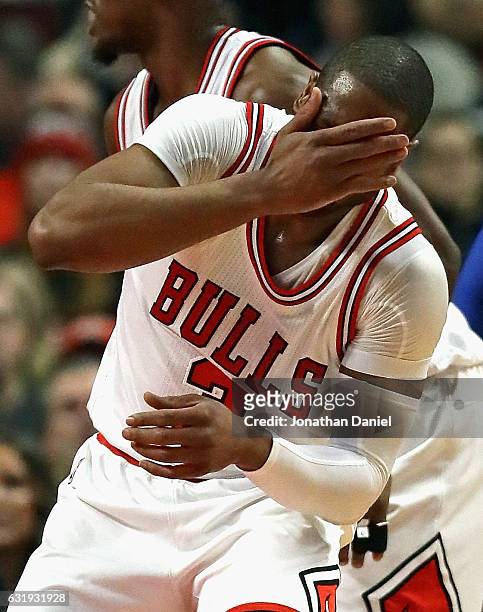 Dwyane Wade of the Chicago Bulls reacts after getting smacked in the face against the Dallas Mavericks at the United Center on January 17, 2017 in...