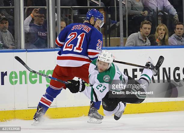 Esa Lindell of the Dallas Stars is tripped up by Derek Stepan of the New York Rangers during the third period at Madison Square Garden on January 17,...