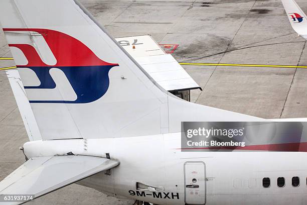 The Malaysian Airlines Bhd. Logo is seen on the tail fin of an aircraft at Kuala Lumpur International Airport in Sepang, Selangor, Malaysia, on...