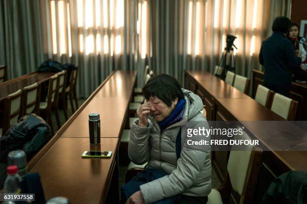 Relative of missing Chinese passengers aboard Malaysia Airlines Flight 370 that disappeared on March 8, 2014 cries before a meeting in Beijing on...