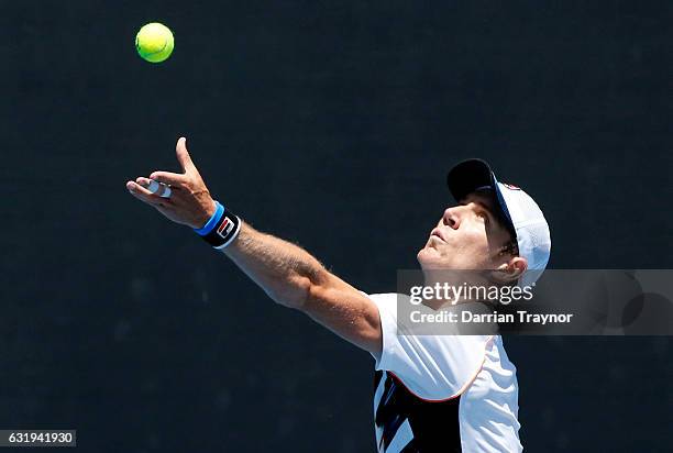 Matthew Barton of Australia serves during his first round doubles match against Vasek Pospisil of Canada and Radek Stepanek of the Czech Republic on...