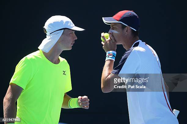 Marc Polmans and Andrew Whittington of Australia talk tactics in their first round doubles match against Yen-Hsun Lu and Jiri Vesely on day three of...