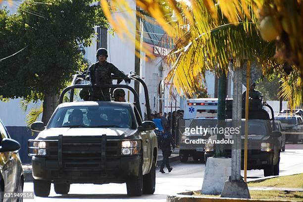 Soldiers patrol near the State Prosecutor Office where a group of gunmen attacked the place in Cancun, Mexico on January 17, 2017. Shootings left...