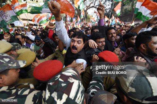 Indian security personnel and activists supporting the Congress Party clash during a protest against demonetisation at the Reserve Bank of India in...