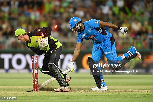 Kieron Pollard of the Strikers is run out by Jay Lenton of the Thunder during the Big Bash League match between the Sydney Thunder and the Adelaide...