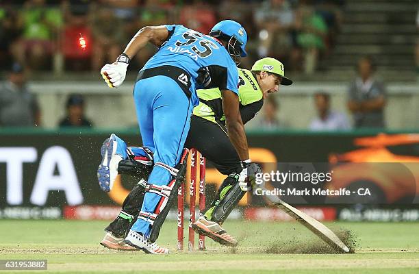 Kieron Pollard of the Strikers is runout by Jay Lenton of the Thunder during the Big Bash League match between the Sydney Thunder and the Adelaide...