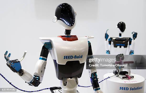 Corp.'s Seed-noid robot, left, is demonstrated at the Robodex trade show on January 18, 2017 in Tokyo, Japan. Approximately 160 exhibitors...