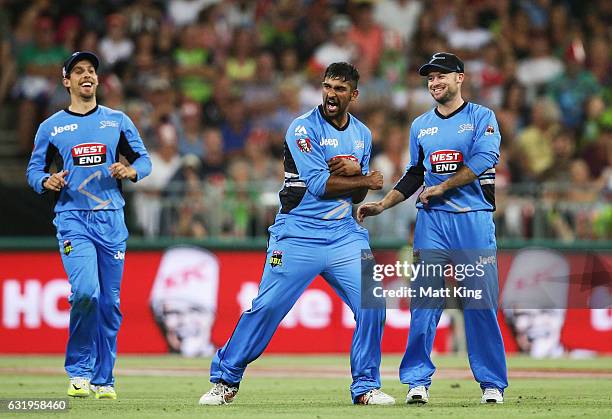 Ish Sodhi of the Strikers celebrates with team mates after taking the wicket of Carlos Brathwaite of the Thunder during the Big Bash League match...