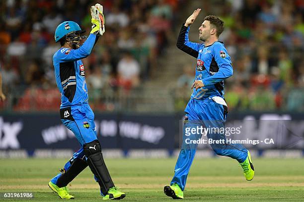Liam O'Connor of the Strikers celebrates with team mates after taking the wicket of Kurtis Patterson of the Thunder during the Big Bash League match...