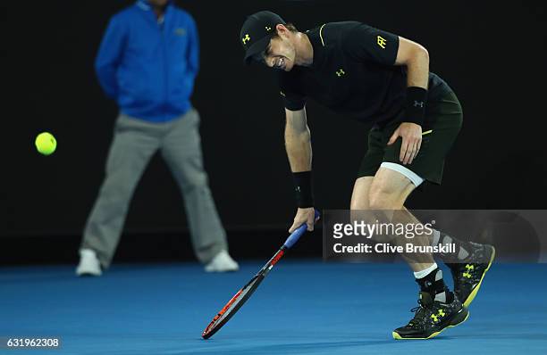 Andy Murray of Great Britain shows his discomfort as he trys to run for the ball after injuring his ankle after he fell over in his second round...