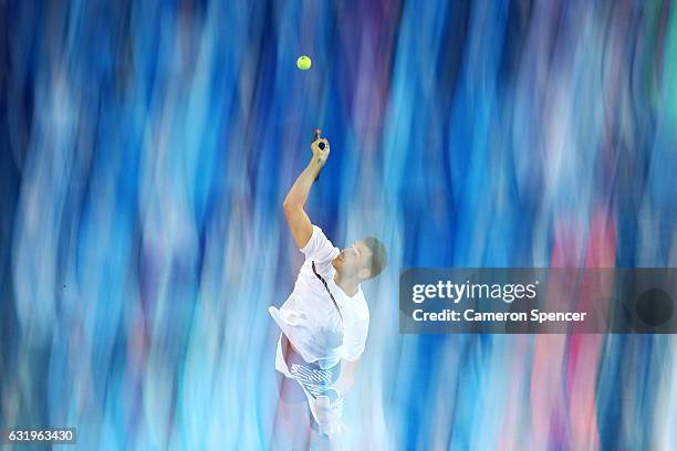 Bernard Tomic of Australia serves in his second round match against Victor Estrella Burgos of The Dominican Republic on day three of the 2017...