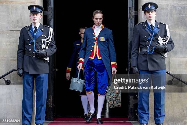 Servant carries bags of Princess Beatrix as she leaves the new year reception for the diplomatic corps at the royal palace on January 18, 2017 in...