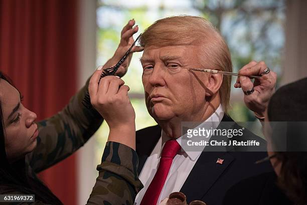 Hair stylist Gemma Sim and make up artist Chris Gargiulo put finishing touches in place as Madame Tussauds unveils a wax figure of President-Elect...