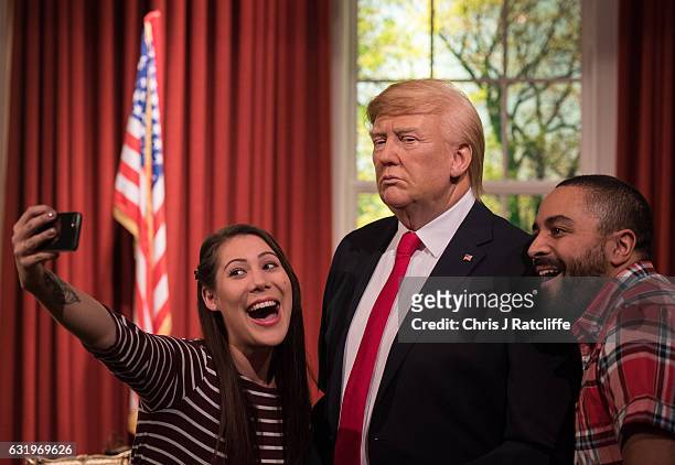Helen Smith and Jason Holliday pose for photographs taking a selfie as Madame Tussauds unveils a wax figure of President-Elect Donald J. Trump ahead...