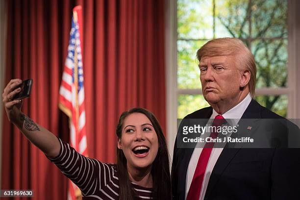Helen Smith poses for photographs taking a selfie as Madame Tussauds unveils a wax figure of President-Elect Donald J. Trump ahead of the...