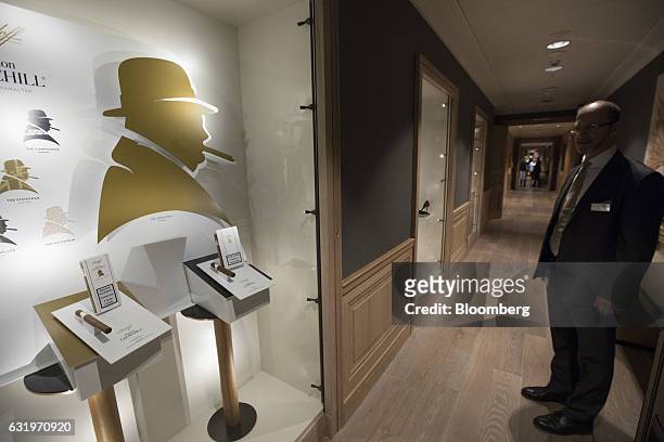 Silhouettes of former U.K. Prime Minister Winston Churchill adorn a wall beside a luxury cigar display, manufactured by Davidoff & Cie SA, in the new...