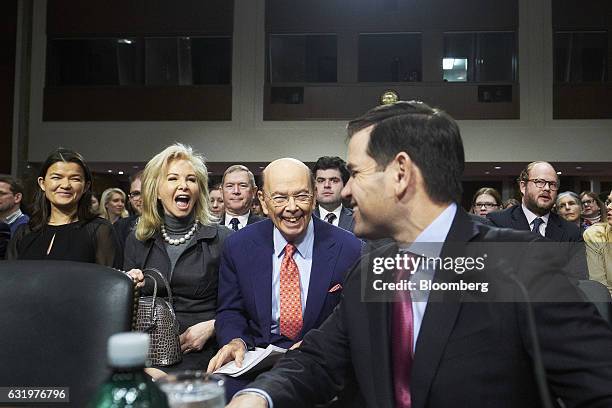 Billionaire investor Wilbur Ross, commerce secretary nominee for U.S. President-elect Donald Trump, center, and his wife Hilary Geary smile as...