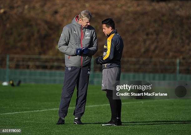 Arsenal manager Arsene Wenger with Alexis Sanchez during a training session at London Colney on January 18, 2017 in St Albans, England.