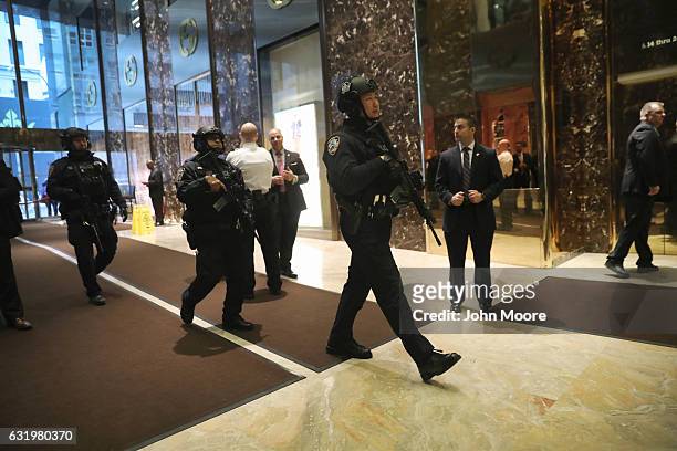 Security officers walk through the lobby of Trump Tower on January 18, 2017 in New York City. President-elect Donald Trump is to be sworn in as the...