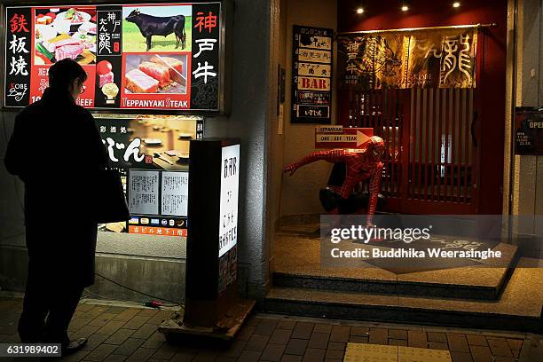 Customer looks Kobe beef cuisines menu display outside the Kobe beef restaurant on January 18, 2017 in Kobe, Japan. Kobe city is home to renowned...