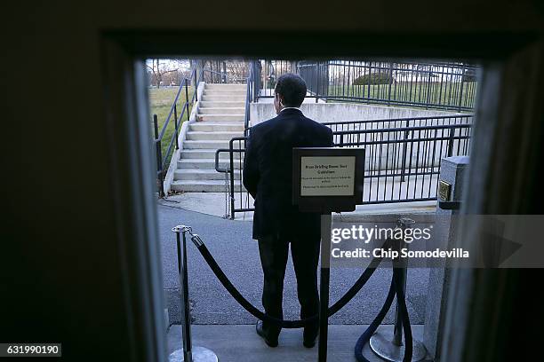 Secret Service agent stands watch outside the door of the Brady Press Briefing Room during President Barack Obama's last news conference at the White...