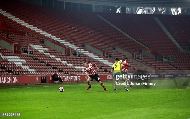 Josh Sims of Southampton goes past Russell Martin of Norwich City with empty seats in the stadium during The Emirates FA Cup Third Round Replay match...