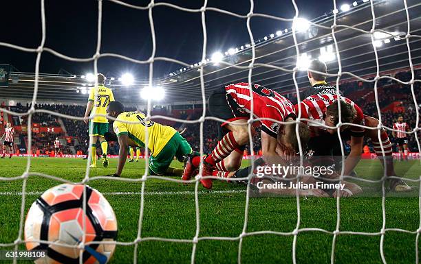 Shane Long of Southampton lies on the ground, congratulated by team mates after scoring the opening goal during The Emirates FA Cup Third Round...