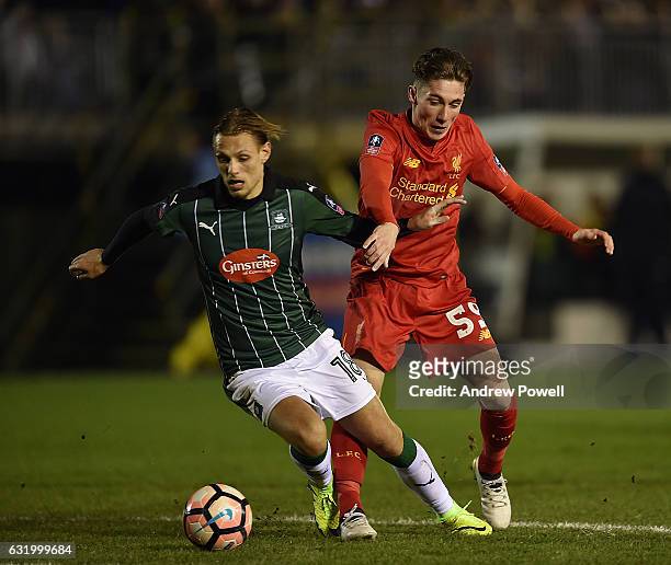 Harry Wilson of Liverpool with Oscar Threlkeld during the Emirates FA Cup Third Round replay match between Plymouth Argyle and Liverpool at Home Park...