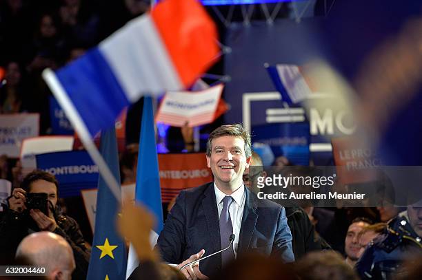 Former Economy Minister and Left-Wing Primaries Candidate Arnaud Montebourg sings the French National Anthem waves at the crowd as he arrives for his...