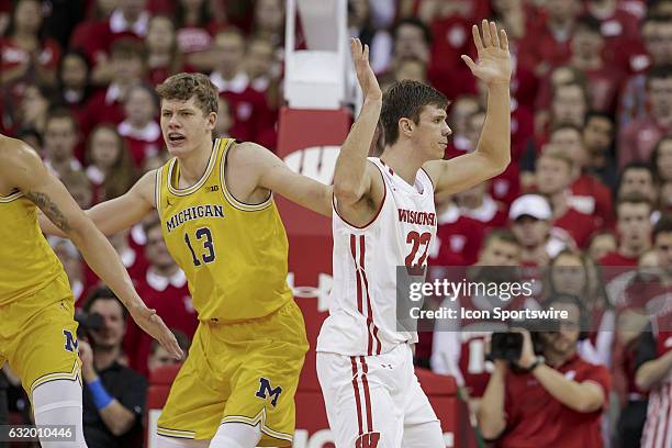 Wisconsin Badgers forward Ethan Happ reacts to a no call with Michigan Wolverines forward Moritz Wagner during an NCAA Basketball game between the...