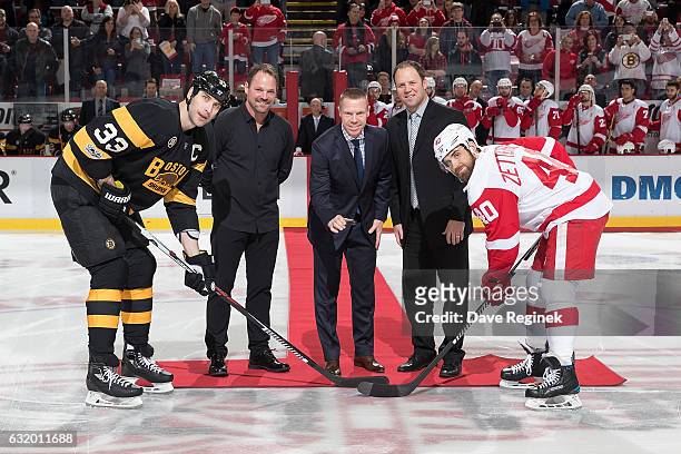 Members of the 1997-1998 Detroit Red Wing Grind Line Joey Kocur, Kris Draper and Kirk Maltby ceremoniously drop the puck between captains Zdeno Chara...