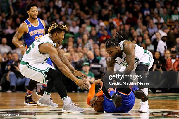 Marcus Smart of the Boston Celtics and Jae Crowder battle Carmelo Anthony of the New York Knicks for a loose ball during the first half at TD Garden...