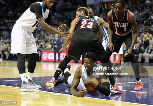 Roy Hibbert of the Charlotte Hornets dives for a loose ball against Allen Crabbe of the Portland Trail Blazers during their game at Spectrum Center...
