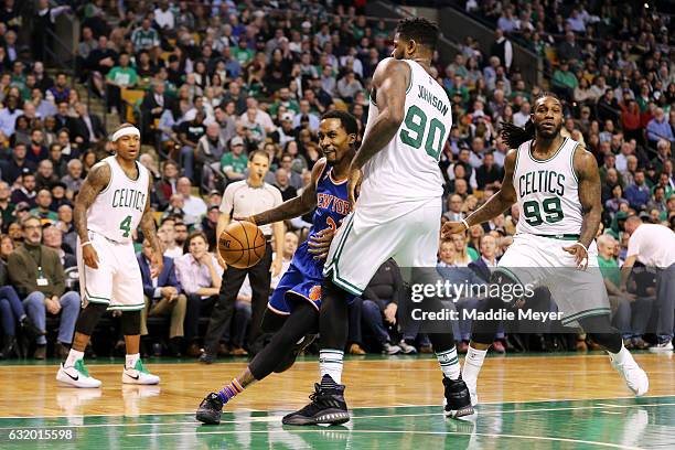 Brandon Jennings of the New York Knicks drives against Amir Johnson of the Boston Celtics during the first half at TD Garden on January 18, 2017 in...