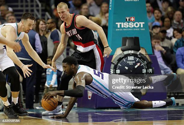 Mason Plumlee of the Portland Trail Blazers watches as Roy Hibbert of the Charlotte Hornets dives for a loose ball during their game at Spectrum...