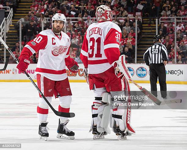 Jared Coreau of the Detroit Red Wings skates to the bench in front of teammate Henrik Zetterberg after being pulled during the first period of an NHL...