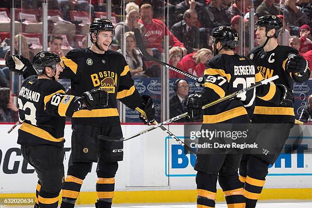 Brandon Carlo of the Boston Bruins celebrates his first period goal with teammates Brad Marchand, Patrice Bergeron and Zdeno Chara during an NHL game...