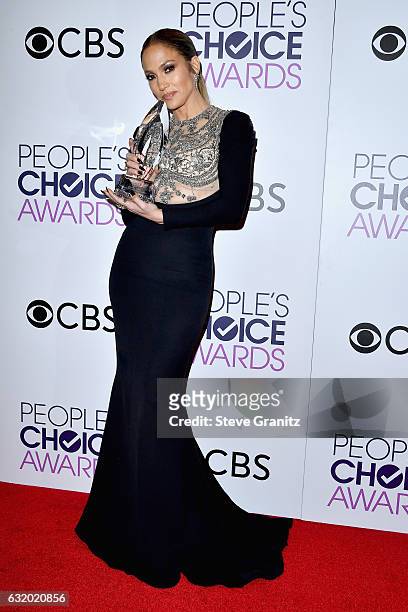 Entertainer Jennifer Lopez poses with an award in the press room during the People's Choice Awards 2017 at Microsoft Theater on January 18, 2017 in...