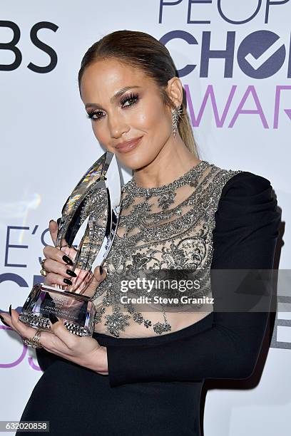 Entertainer Jennifer Lopez poses with an award in the press room during the People's Choice Awards 2017 at Microsoft Theater on January 18, 2017 in...