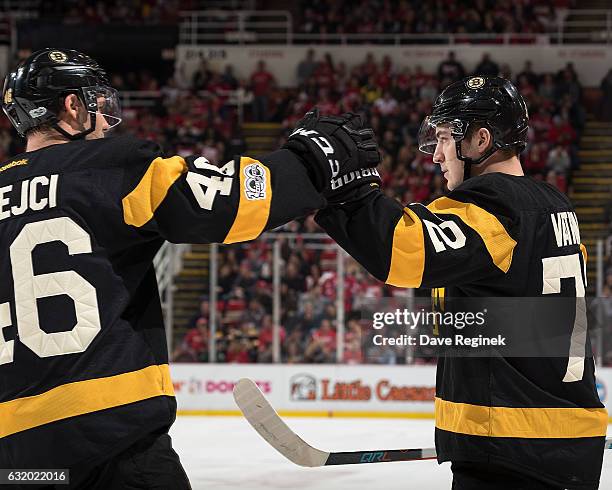 Frank Vatrano of the Boston Bruins celebrates his first period goal with teammate David Krejci during an NHL game against the Detroit Red Wings at...