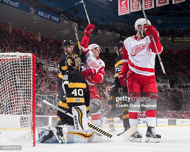 Dylan Larkin of the Detroit Red Wings celebrates his first period goal with teammate Riley Sheahan in front of Tuukka Rask, Dominic Moore and Frank...