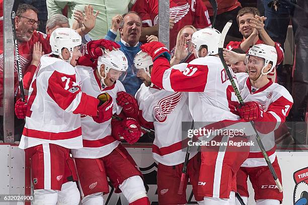 Gustav Nyquist of the Detroit Red Wings celebrates his third period goal with teammates Dylan Larkin, Tomas Tatar, Xavier Ouellet and Nick Jensen...