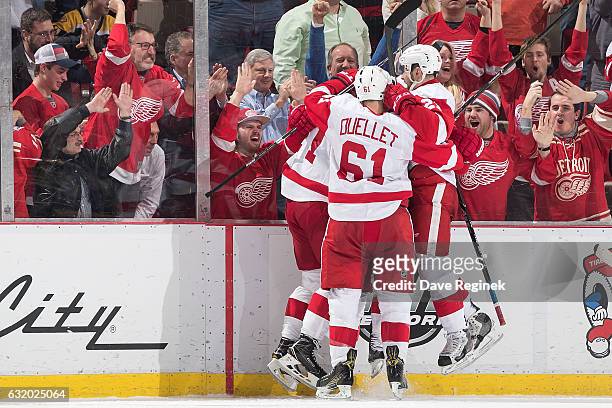Gustav Nyquist of the Detroit Red Wings celebrates his third period goal with teammates Dylan Larkin, Tomas Tatar and Xavier Ouellet during an NHL...