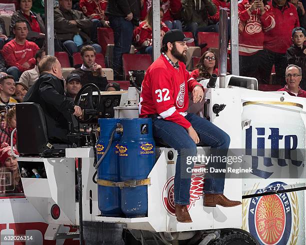 Detroit Tigers pitcher Michael Fulmer rides the Zamboni with Al Sobotka during the second intermission of an NHL game between the Detroit Red Wings...