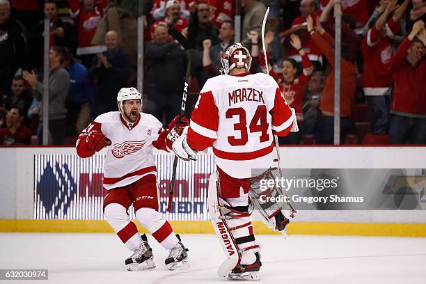 Petr Mrazek of the Detroit Red Wings celebrates a 6-5 shootout win over the Boston Bruins with Tomas Tatar at Joe Louis Arena on January 18, 2017 in...